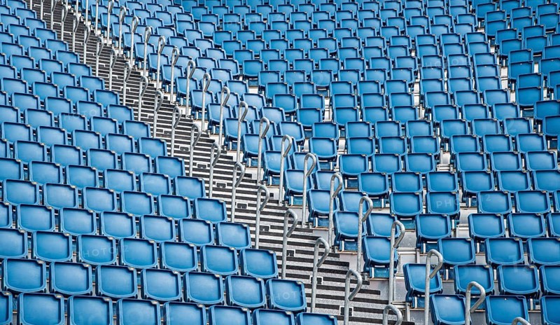 Blue plastic empty stadium or stage chairs in a row