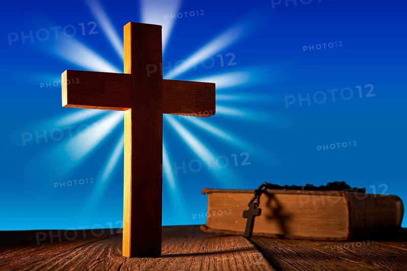 Christian wood cross on blue sky wooden made with Bible and rosary beads