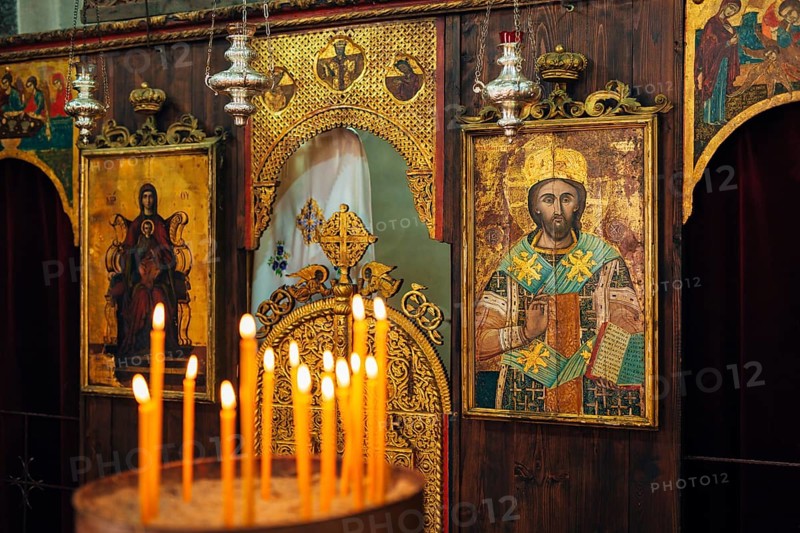 The interior of the church. Icons, chandelier, candles in a small Christian Orthodox church in Montenegro