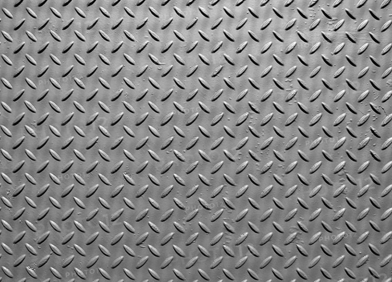 Grey steel metal plate with painted surface and industrial safety diamond pattern texture