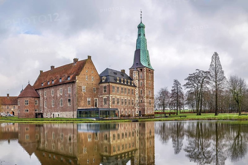 Water castle Raesfeld in Muensterland, North Rhine-Westphalia, Germany. View with lake