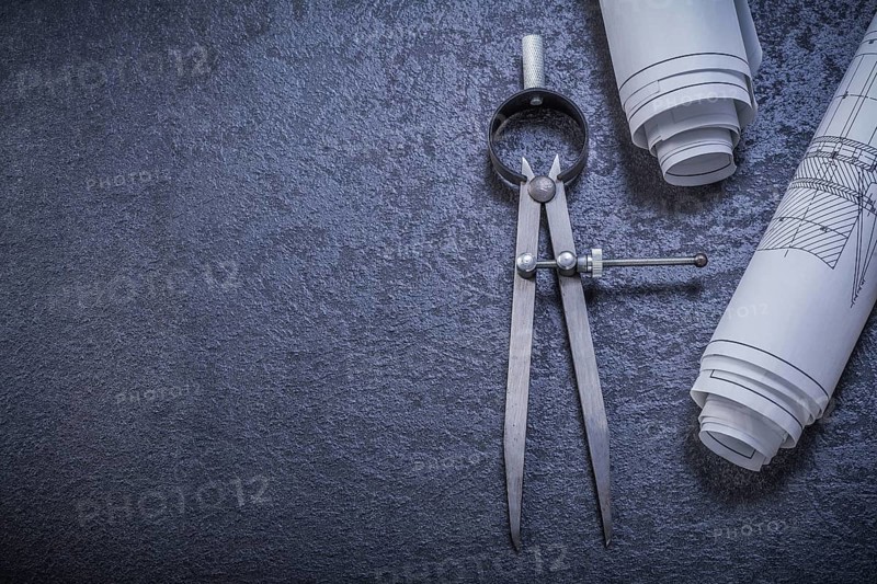 Construction drawings pair of compasses on black background maintenance concept