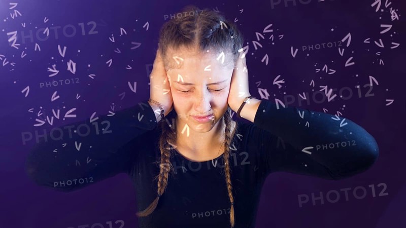 Teenage girl dressed casual with pigtails, being attacked by social media, creating emotional stress, bullying