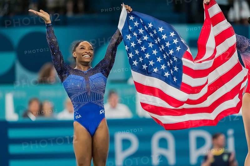 Simone Biles (USA) of the United States celebrates with the fans after winning the Artistic Gymnastics Women's All-Around Final at the Bercy Arena during the 2024 Paris Summer Olympics in Paris, France