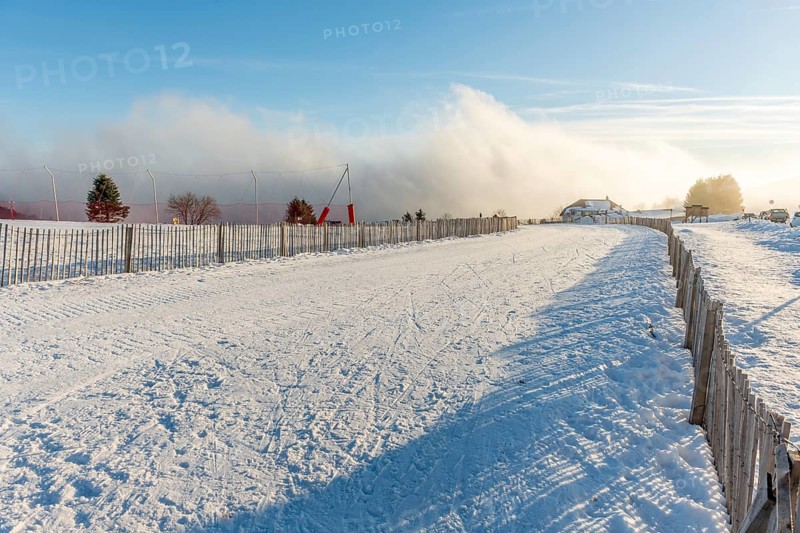 Cross-country ski trail in the snowy mountain on a sunny day. France, Vosges