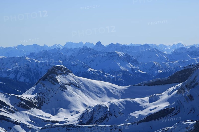 Snow covered mountain Ranges in the Swiss and Austrian Alps seen from Chaeserrugg