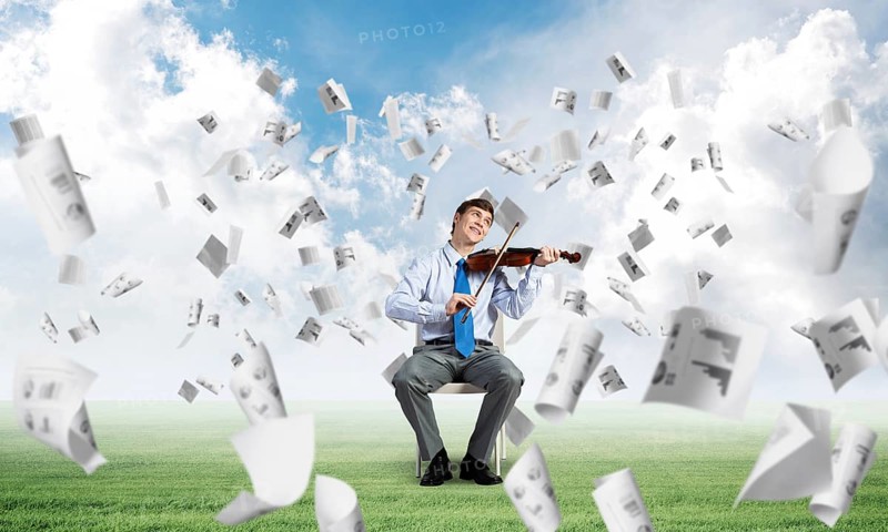 Young businessman is engaged in music, concept of creative chaos in business