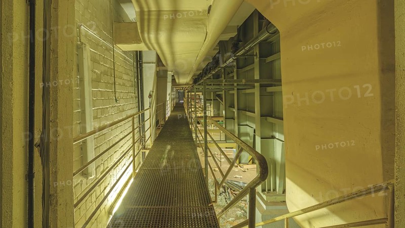 Industrial interior with a raised walkway and metal grating, surrounded by pipes and railings, Bad am Park, Lost Place, Essen, North Rhine-Westphalia, Germany