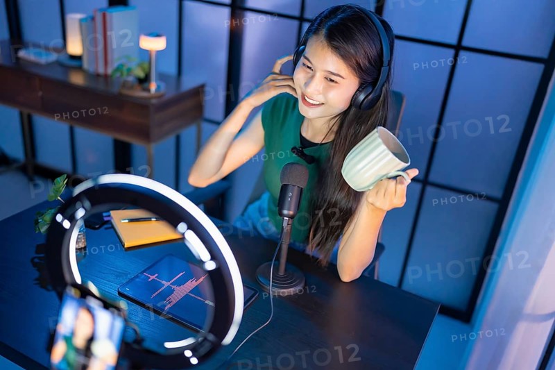 Content creator Young asian woman influencer creating content in home studio entertainment and communication blogger video record with smartphone for online vlog