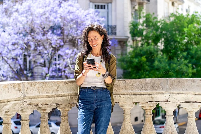 Urban woman engaged in texting on her smartphone