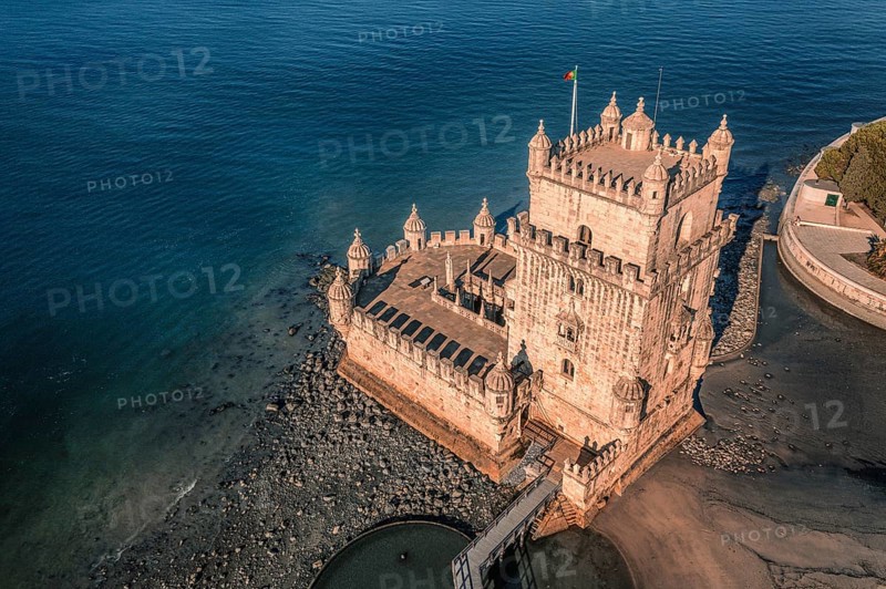 Aerial image of Belem tower, Lisbon, Portugal at summer day. Medieval fortification on Tagus river in late Gothic or Manueline style, UNESCO world heritage site, Age of Discoveries, tourist attraction, Portuguese seafaring history