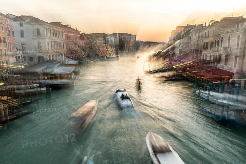 Evening light at sunset, view over the Grand Canal, gondola and boats, from the Rialto Bridge, zoom effect, Venice, Veneto, Italy