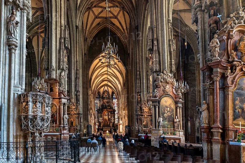 Vienna, Austria, 22 September, 2022: view of the central nave and altar during morning church service inside the historic St. Stepehen's Cathedral in Vienna