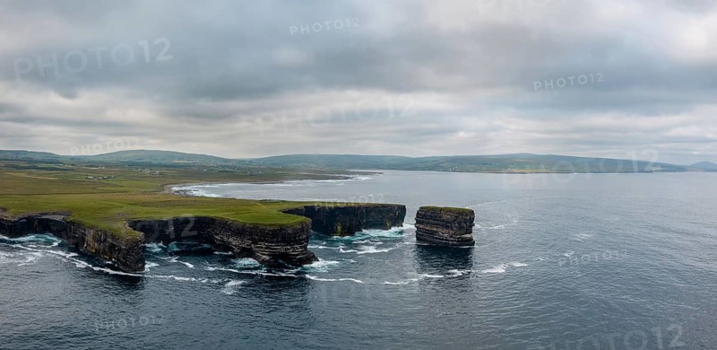 A drone panorama landscape of the Downpatrick Head sea stack and cliffs and coastline of northern County Mayo in Ireland