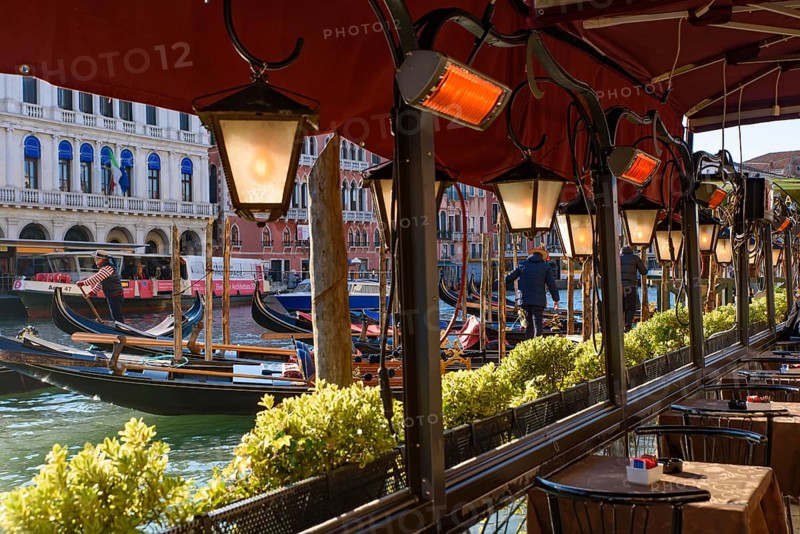 View of the Grand Canal, Rialto Bridge, and gondolas from outdoor restaurant seats, Venice, Italy