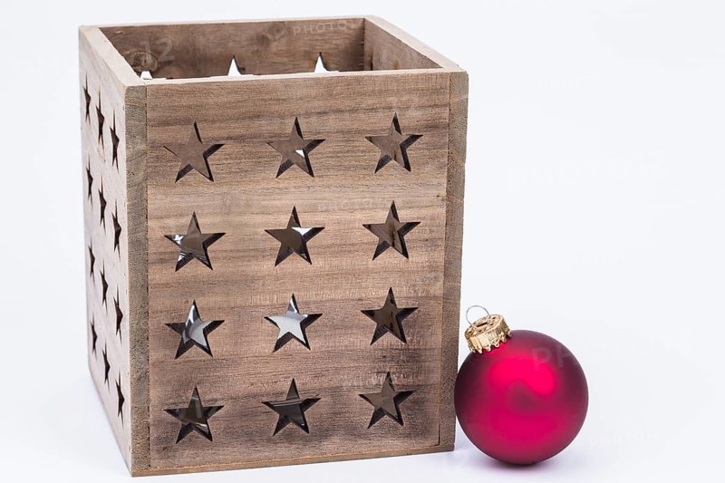 The photo shows a lantern with a red Christmas bauble