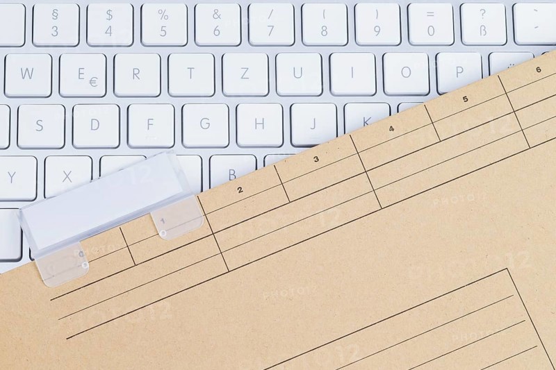 The photo shows a white keyboard with a briefcase