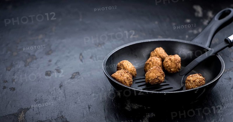 Slate slab with homemade Meatballs (selective focus, close-up shot)