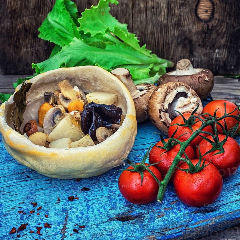 Vegetable hot plate made of baked dough cooked in a rustic style.Photo tinted