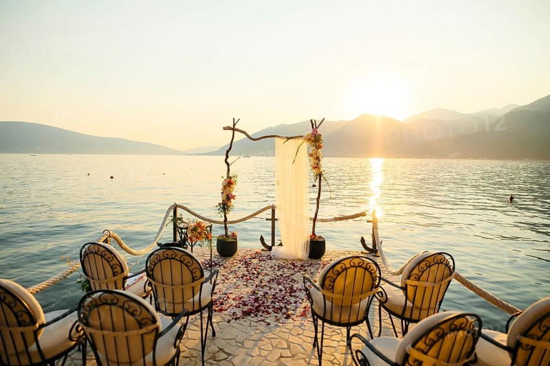 Wooden arch for the wedding ceremony at sunset. On the shore of the Bay of Kotor, Tivat, Montenegro
