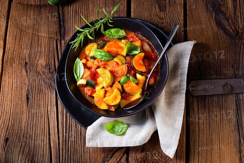 Vegetarian courgette ratatouille with tomato sauce and herbs