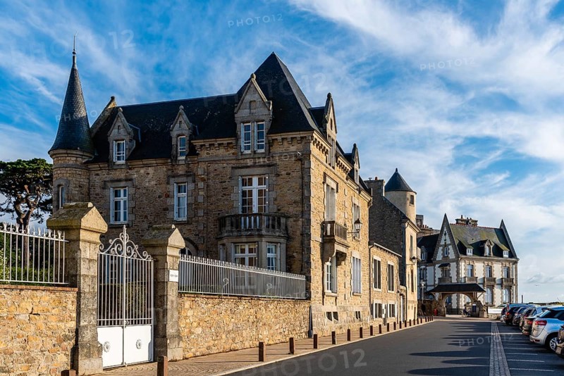 Roscoff, France, July 31, 2018: Old residential buildings and health resorts at evening against sky