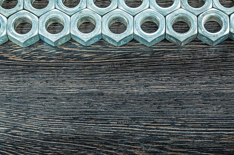 Stainless nuts on wooden board