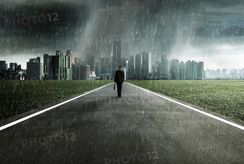 Business man facing a storm, victory concept