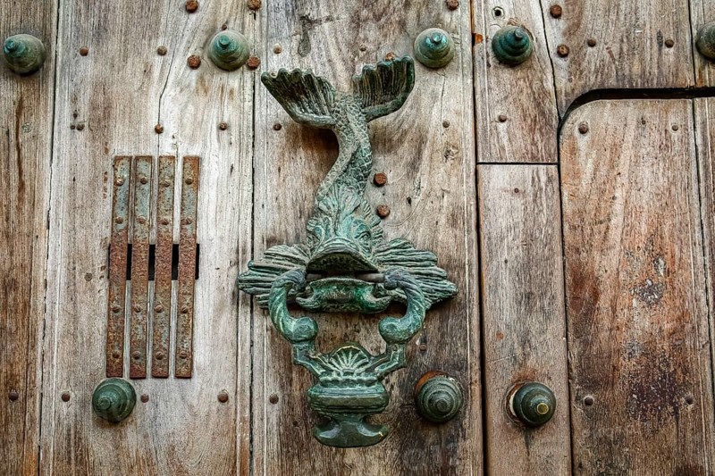 Artful door knocker at an old wooden door, Cartagena, Colombia