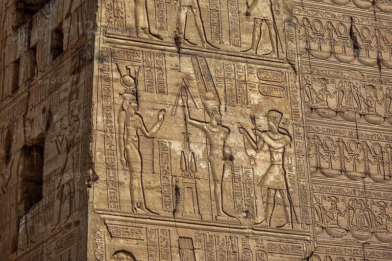 Hieroglyphic carvings on the exterior walls of an ancient egyptian temple