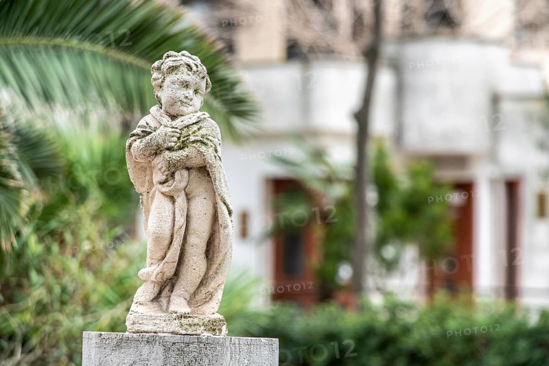 Baroque sculpture of a child in a park in Trani, Southern Italy