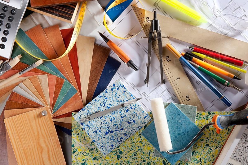 Architect or interior designer workplace desk and design tools with lots of construction material samples