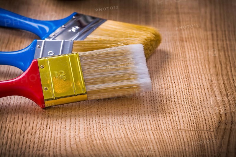 Very close up view on stack of three paint brushes