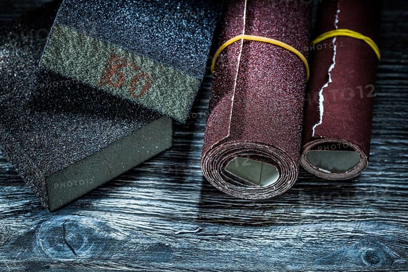 Rolled abrasive paper blocks on vintage wooden board