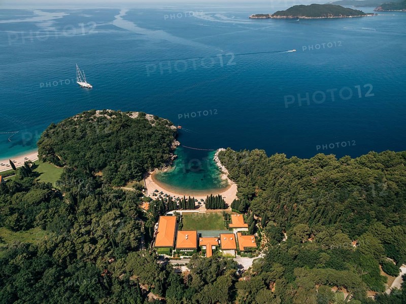 Budva, Montenegro - 10 june 2019: Hotel spa Aman Resorts Sveti Stefan. A luxury hotel on the Adriatic coast in Montenegro. Beach and coastline. Aerial photo. The concept of a rich luxury life