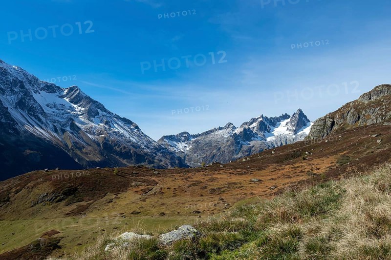 Beautiful autumn landscape in the central Alps, Switzerland. Orange colours and alpine wilderness on a beautiful afternoon
