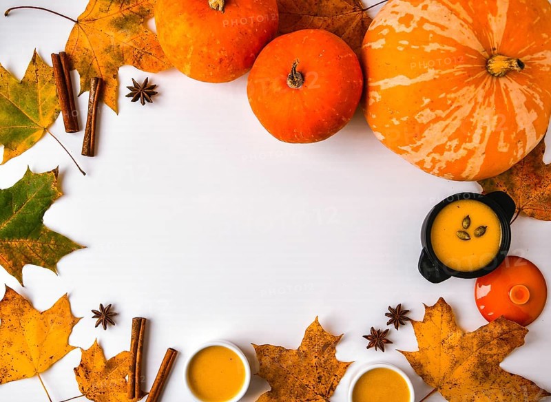 Autumn food. Frame of pumpkin puree soup, leaves. Top view. Autumn harvest, pumpkins, leaves on grey as abstract background. View from above. Thanksgiving day. Flat lay. Copy space