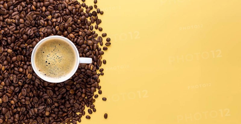 International coffee day, a cup of Arabica coffee beans on a yellow background