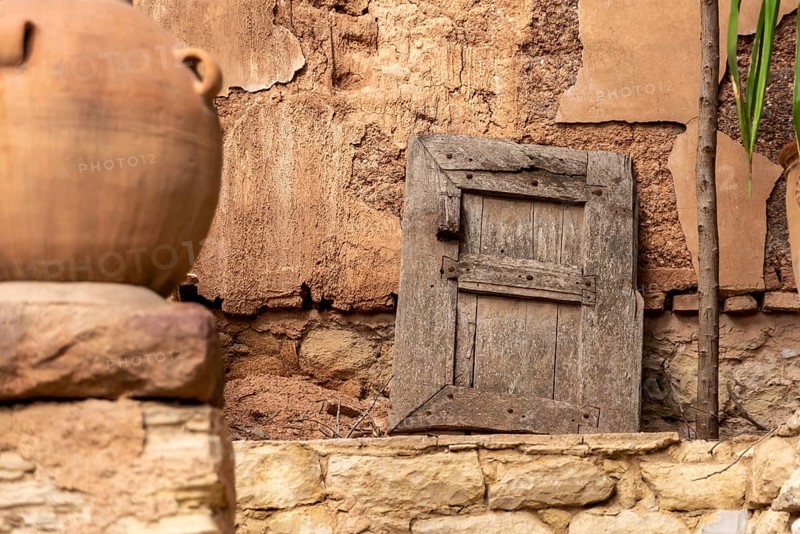 Beautiful old window shutter leaning at a facadeof a house in Agadir, Morocco