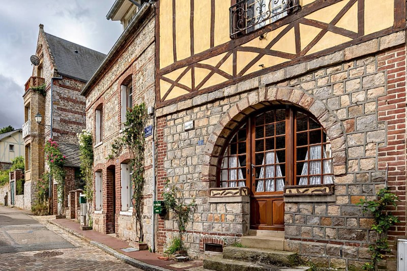 Charming stone and half-timbered houses with large windows in an old street, The historic mill village of Veules Les Roses in Normandy, France