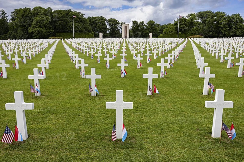 White crosses of an American military cemetery on a green lawn, lined with flags, Luxembourg American Cemetery and Memoria, Luxembourg, Grand Duchy of Luxembourg