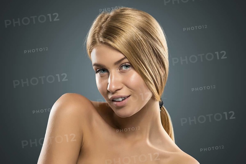 Portrait beautiful blond woman with blue eyes in azure background. Closeup