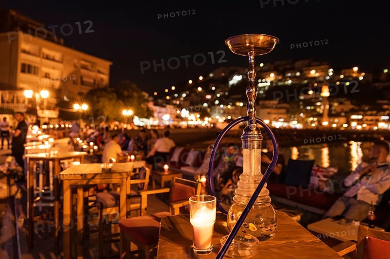 Shisha on the table in restaurant, in the background city Ulcinj in Montenegro at night.