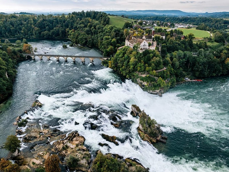 Aerial view of the Rhine Falls with railway viaduct and Laufen Castle in autumn, Neuhausen, Canton Schaffhausen, Switzerland