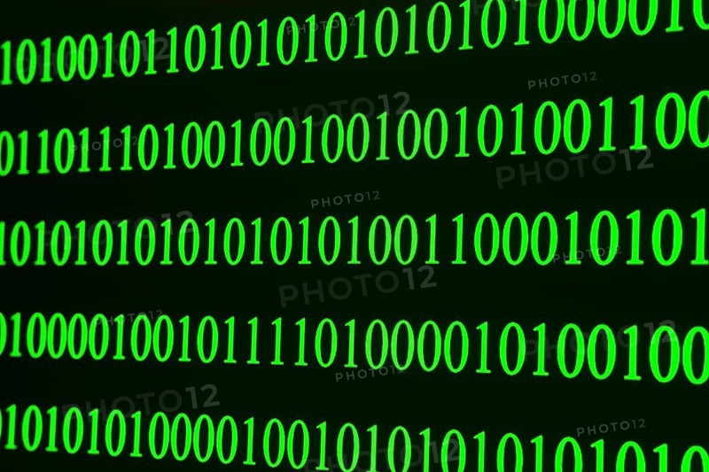 Green binary code in clear rows on a black background