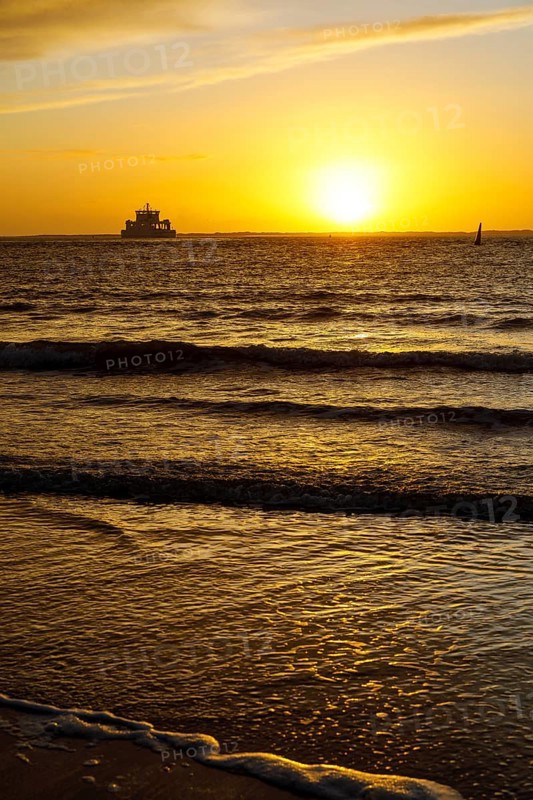 Intense sunset on the west beach of Norderney, Lower Saxony, Germany