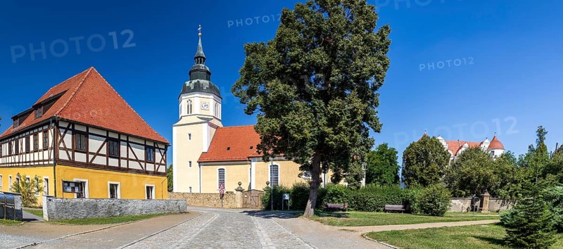 St George's Church and moated castle, Großkmehlen village square, Ortrand, Brandenburg, Germany