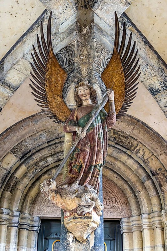 Tower porch with statue of St Michael the Archangel. Protestant parish church of St Michael. As Johannes Brenz's place of work, it was the starting point of the Reformation in the territory of the imperial city after 1523. Schwäbisch Hall, Baden-Württemberg, Germany