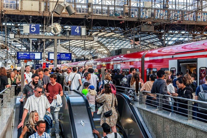 Cologne Central Station. Stairs to the platforms. Travellers waiting for their train on the platform. Crowd with motion blur. Cologne, North Rhine-Westphalia, Germany