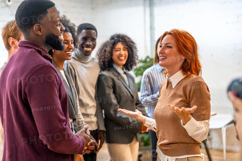 New member of a coworking team presenting herself to diverse colleagues in the office